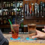 Two people enjoy cocktails at Countryside Pizza and Grills full bar